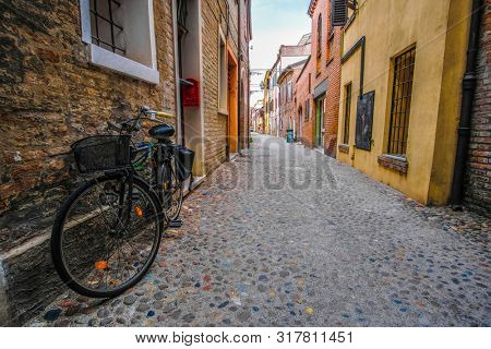 Ferrara, Italy - July,  , 2019: bycicle on a strett of Ferrara , Italy