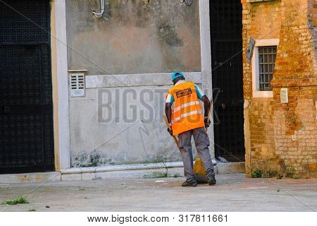 Venice, Italy - July, 11, 2019: Yard-keeper in Venice, Italy
