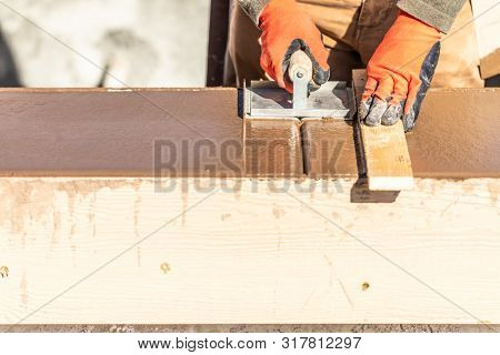 Construction Worker Using Hand Groover On Wet Cement Forming Coping Around New Pool.