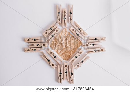 Woodenl Clothespins, Paper Clip And Brown Sticker On White Background. Isolated On White. View From 