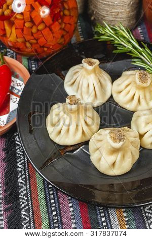 The National Georgian Dish Is Khinkali. Steamed Dough, Veal, Spread With Butter Sauce. National Cuis