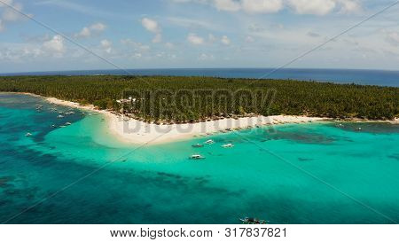 Sandy Beach With Tourists, Palm Trees And Turquoise Water On The Island Of Daco, Philippines, Aerial