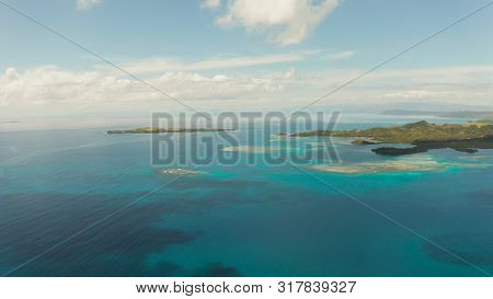Islands Are Surrounded By An Atoll And A Coral Reef With Blue Water Top View. Bucas Grande, Philippi