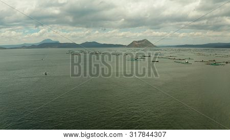 Taal Volcano On An Island In Middle Lake With Fish Farm, Aerial View. Luzon, Philippines Tropical La