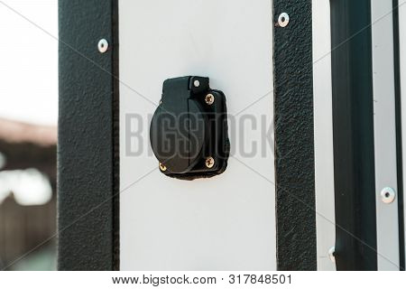 Photo Of A Moisture-proof Socket On A White Wall