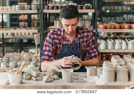 Talanted Caucasian Man Making Decoration For Cup.