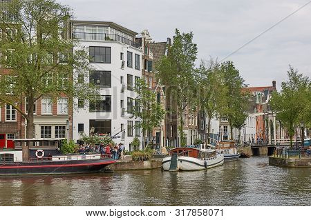 Tourist Boat In One Of The Many Canals In Amsterdam Netherlands.