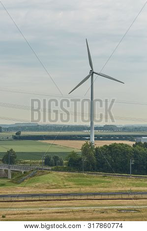 Windmills As Wind Turbine Power Generators Placed Within The Countryside Of Green Country Of Netherl