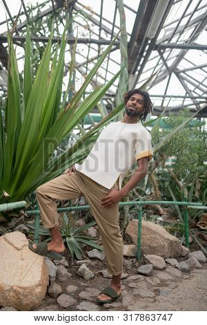 Bearded Man Posing While Promoting Summer Collection