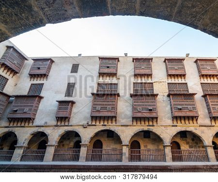Facade Of Historic Wikala Of Bazaraa Building Through Stone Arch , With Vaulted Arcades And Oriental