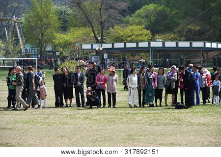 Pyongyang, North Korea - May 1, 2019: Local People And Tourists From Different Countries Gathered To