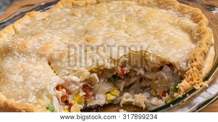 A Hot, Home Made Chicken Pot Pie With Brown Crust And Serving Missing