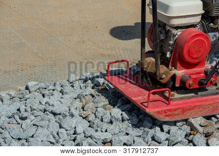 Rammer At Work. Rammer Rubble On The Edge Of The Road. Construction Work On The Road