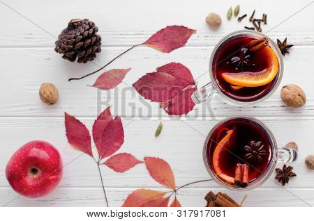 Autumn Mulled Wine Or Gluhwein Based On Red Wine With Orange, Apple And Spices Cinnamon Sticks, Star