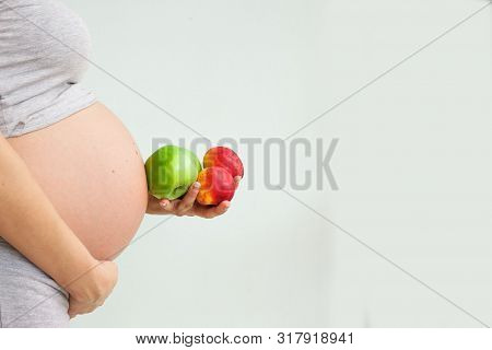 Pregnant Woman With Fruit In Her Hands. Vitamins For Pregnant Women. Vegetarianism. Useful Products