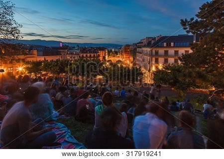 Spectators Waiting For Fireworks Festival Show At Observatory Park Hill Over Geneva City At Dusk Dur