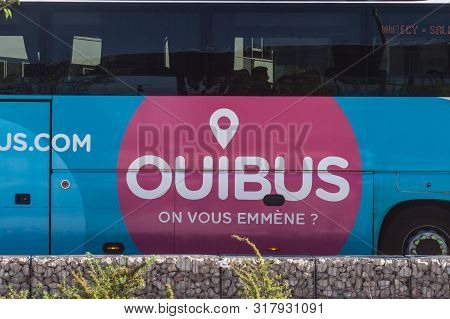 Lyon, France - July 13, 2019: Ouibus Logo In Front Of One Of Their Coaches In Lyon. Formerly Idbus, 