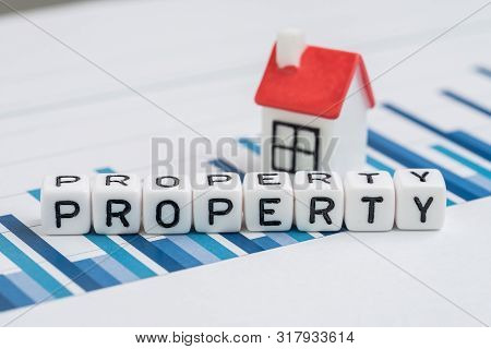 Cube Block With Alphabets Building The Word Property With Small House On Yearly Chart And Graph Repo