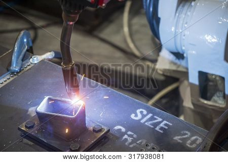 The Hi-technology Additive Material Processing By Robotics Arm. The Robotic Arm Welding The Metal Pa