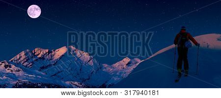 Night skitouring with amazing view of swiss famous mountains in beautiful winter powder snow of Alps. 