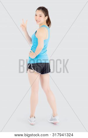 Beautiful Portrait Young Asian Woman In Sport Clothes With Satisfied And Confident Gesture Finger V