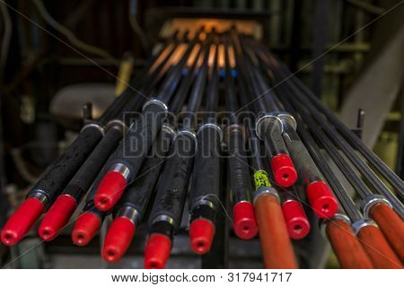 Glass Blowing Pipes Getting Warmed Up In A Traditional Furnace For The Glass Manufacturing Process, 