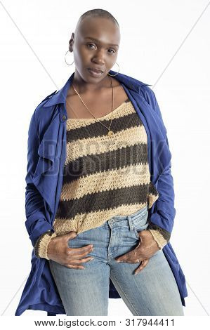 Black African American Fashion Model With Bald Hairstyle Confidently Posing With A Vibrant Blue Colo