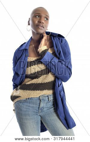 Black African American Fashion Model With Bald Hairstyle Confidently Posing With A Vibrant Blue Colo
