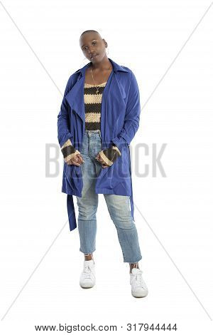 Black African American Fashion Model With Bald Hairstyle Confidently Posing With A Vibrant Blue Colo
