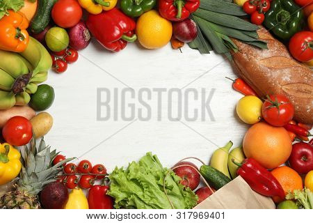 Frame Of Paper Bag With Fresh Vegetables And Fruits On White Wooden Background, Top View. Space For
