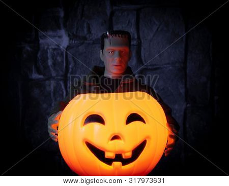 AUG 18 2019: Frankenstein monster holding a glowing jackolantern pumpkin - custom Mego Corporation action figure