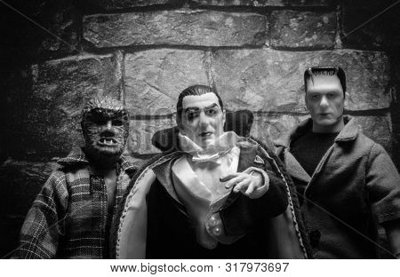 AUG 18 2019: Halloween concept of Frankenstein, Count Dracula and Werewolf - vintage retro movie poster look - Mego Corporation action figures