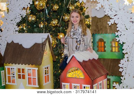Portrait Of A Charming Blonde Girl. Decoration Christmas Tree Interior Preparation For Celebrating, 