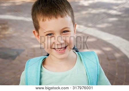 Cute 7 Year Old Caucasian Child Laughing, Expecting To Go To School For The First Time On September 