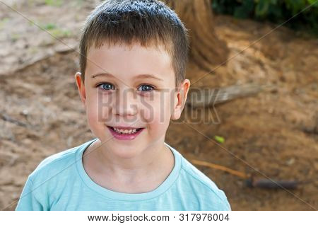 Cute 7 Year Old Caucasian Child Laughing, Expecting To Go To School For The First Time On September 