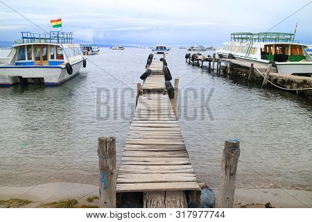 Copacabana Town, Bolivia - April 28, 2018 : Wooden Docks Surrounded By The Boats To Isla Del Sol On 