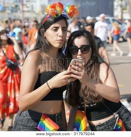 Two Lesbians Take A Selfie On The Phone In The Gay Pride Parade. The Annual Parade Lgbt. Parade Of T