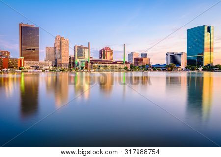 Toledo, Ohio, USA downtown skyline on the Maumee River at dusk.