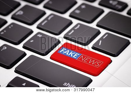 Red Fake News Button On Laptop Keyboard. Fake News On Internet In Modern Digital Age Concept