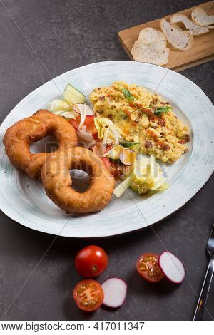 Donuts And Egg Served For Breakfast On A Table