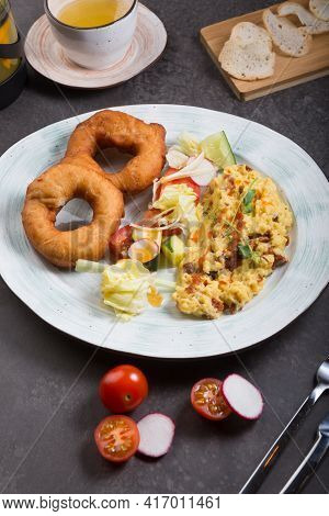 Donuts And Egg Served For Breakfast On A Table