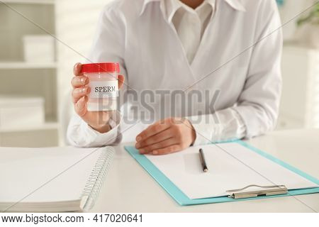 Doctor Holding Container With Sperm In Hospital, Closeup