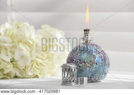 Burning Catalytic Purifying Lamp On Window Sill, Space For Text. Interior Element