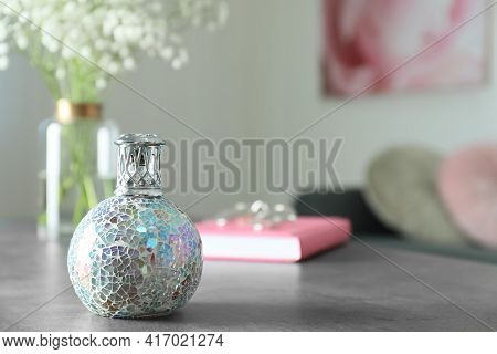 Stylish Catalytic Lamp On Grey Table In Room, Space For Text. Cozy Interior