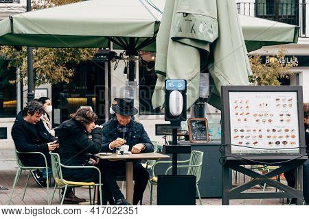Madrid, Spain - January 31, 2021: Unidentified People Sitting In A Sidewalk Cafe Terrace In Historic