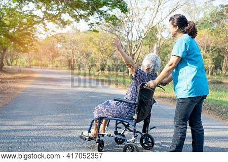 Doctor Help And Care Asian Senior Or Elderly Old Lady Woman Patient Sitting On Wheelchair At Park In