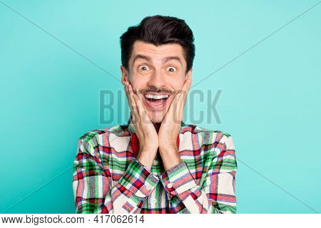 Photo Of Excited Funny Surprised Guy Look Hands Cheeks Open Mouth Wear Plaid Shirt Bow Isolated Blue