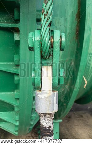 Close Up View Of Of An Old Green Steel Shackle With A Large Nut And Rusty Steel Cable