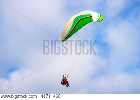 Man Doing Sport, Para-glider In The Clouded Sky. Paragliding Is An Extreme Sport And Recreation. Tor