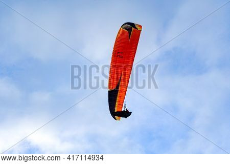 Man Doing Sport, Para-glider In The Clouded Sky. Paragliding Is An Extreme Sport And Recreation. Tor